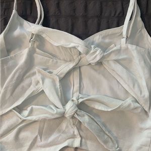 Super cute white button up tank top. Open back with two cute bows, adjustable.